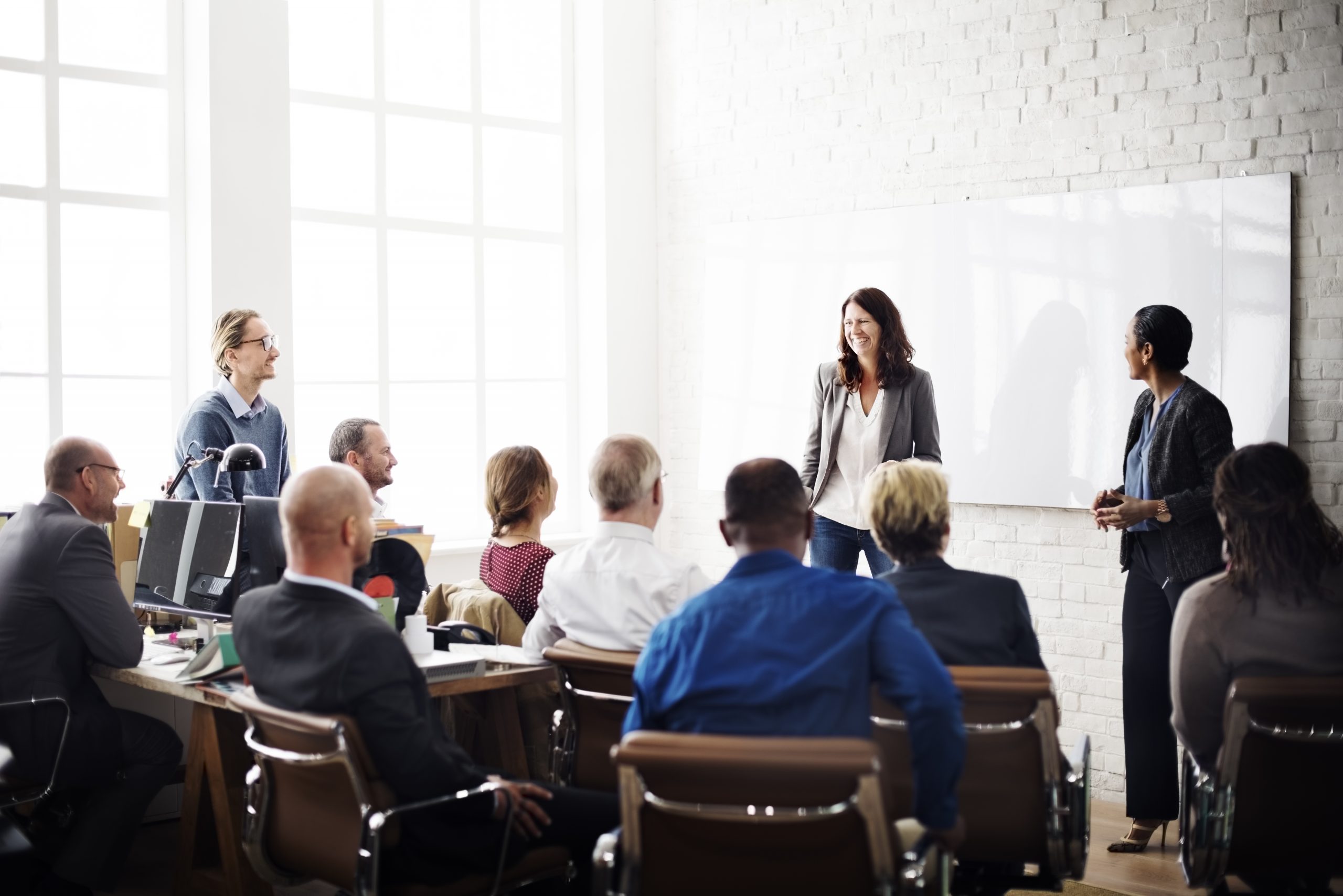 People gather together at a conference table to hold a business meeting. If you need business insurance for your company, then contact Chastain Otis.