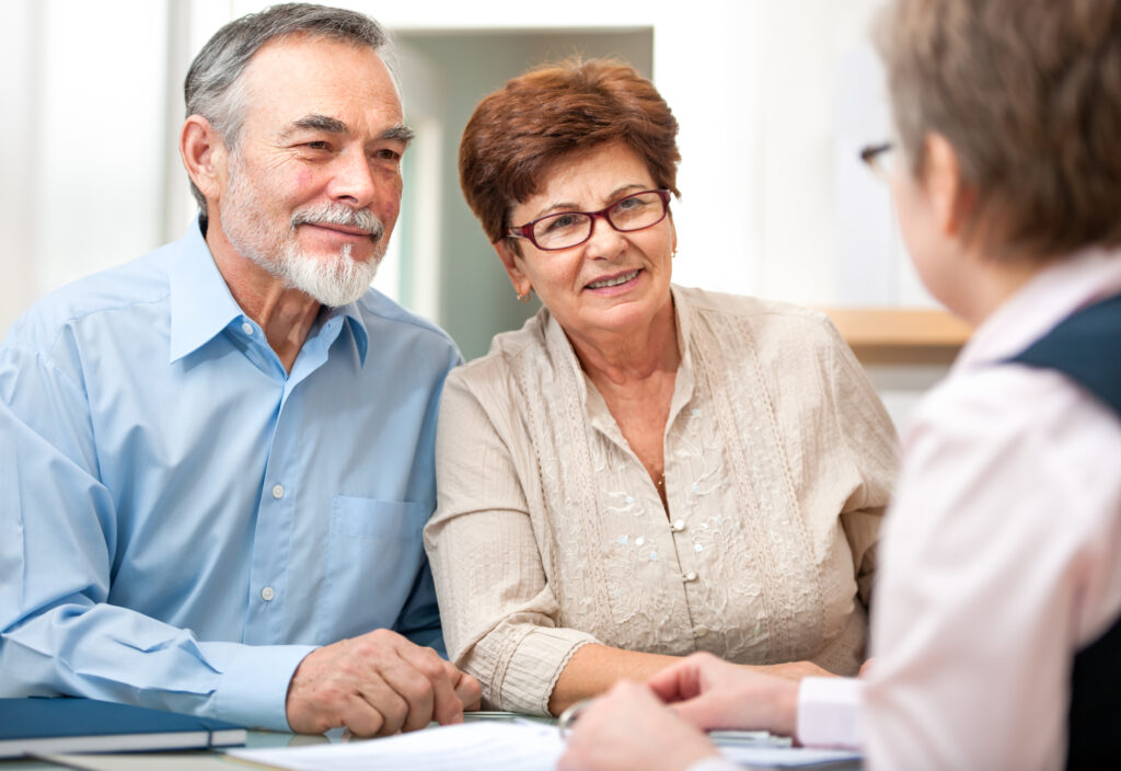 An older couple are talking with an insurance agent.