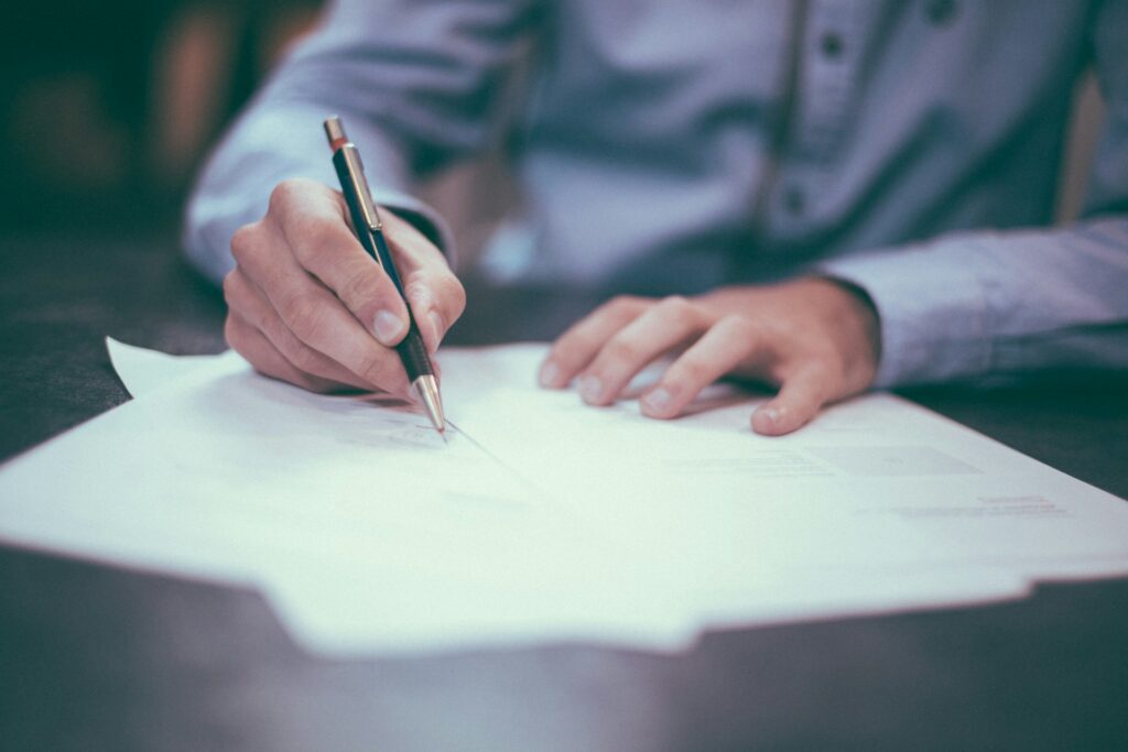 An insurance broker is filling out forms for liability insurance.